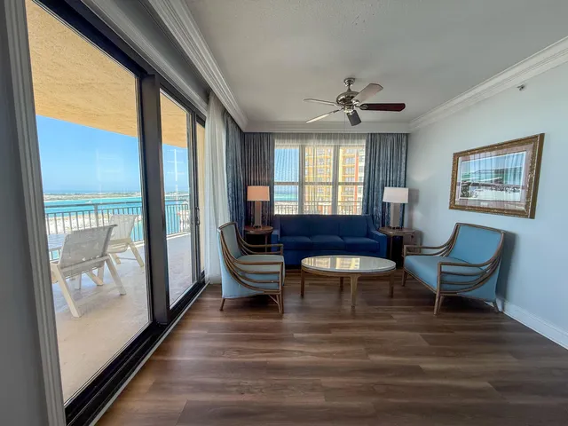 a room with wooden floor and windows