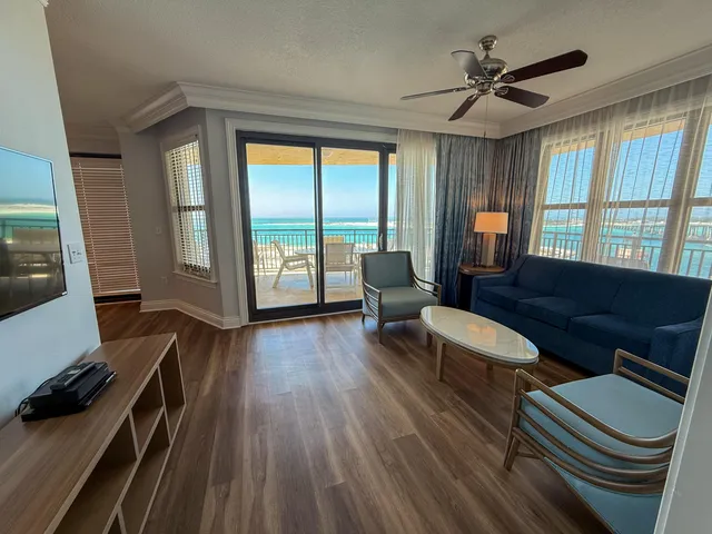 a living room with furniture and a floor to ceiling window
