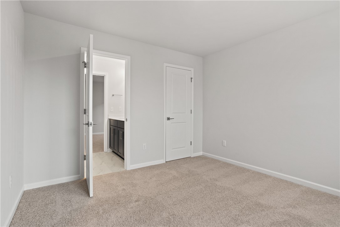 629 Sweetspire Trail, Unit 149 Seneca, SC 29678 - Photo 16 of 30 A spacious bedroom with plush carpeting opens into a private bathroom.