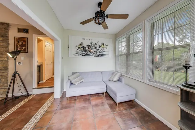 a living room with furniture and a floor to ceiling window