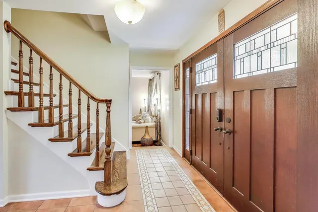 a view of entryway with stairs and a front door