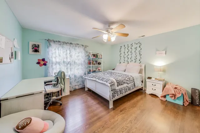 a bedroom with a bed and a chandelier