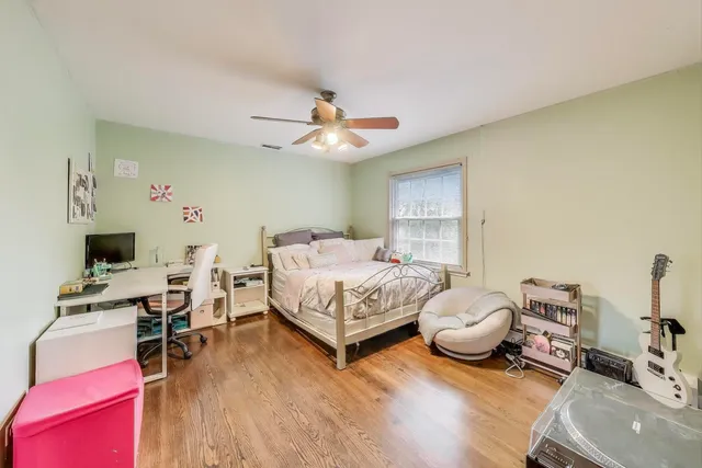 a bedroom with furniture and a wooden floor