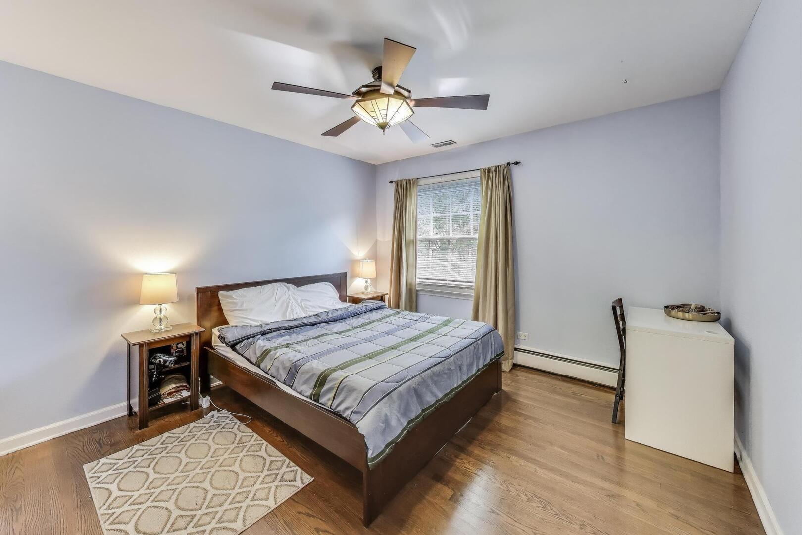 248 Beverly Road Barrington, IL 60010 - Photo 19 of 27 a bedroom with a bed and a chandelier