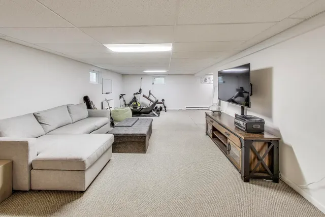 a living room with furniture and a mirror