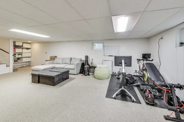 a living room with furniture a air conditioner vent and a window