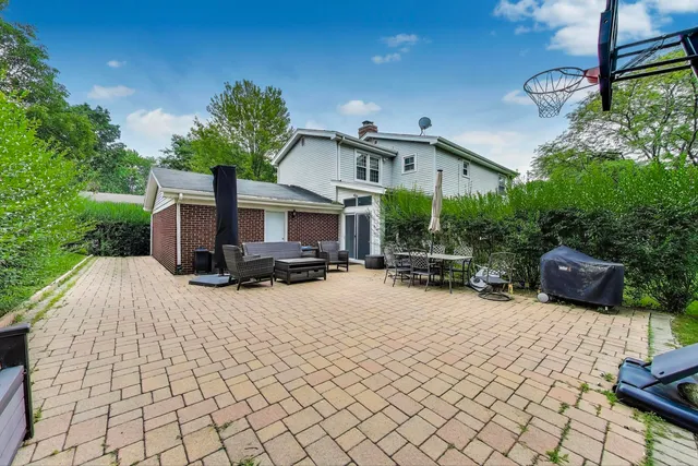 a view of a house with backyard and sitting area