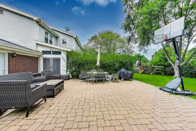 a view of a house with backyard and sitting area