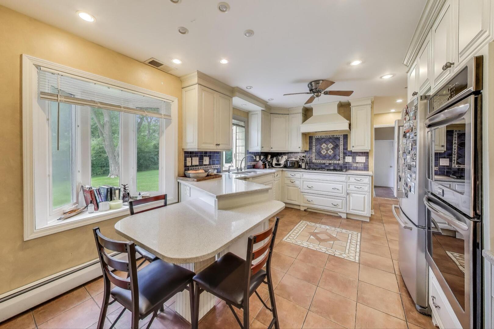 248 Beverly Road Barrington, IL 60010 - Photo 5 of 27 a kitchen with stainless steel appliances kitchen island granite countertop a refrigerator and cabinets