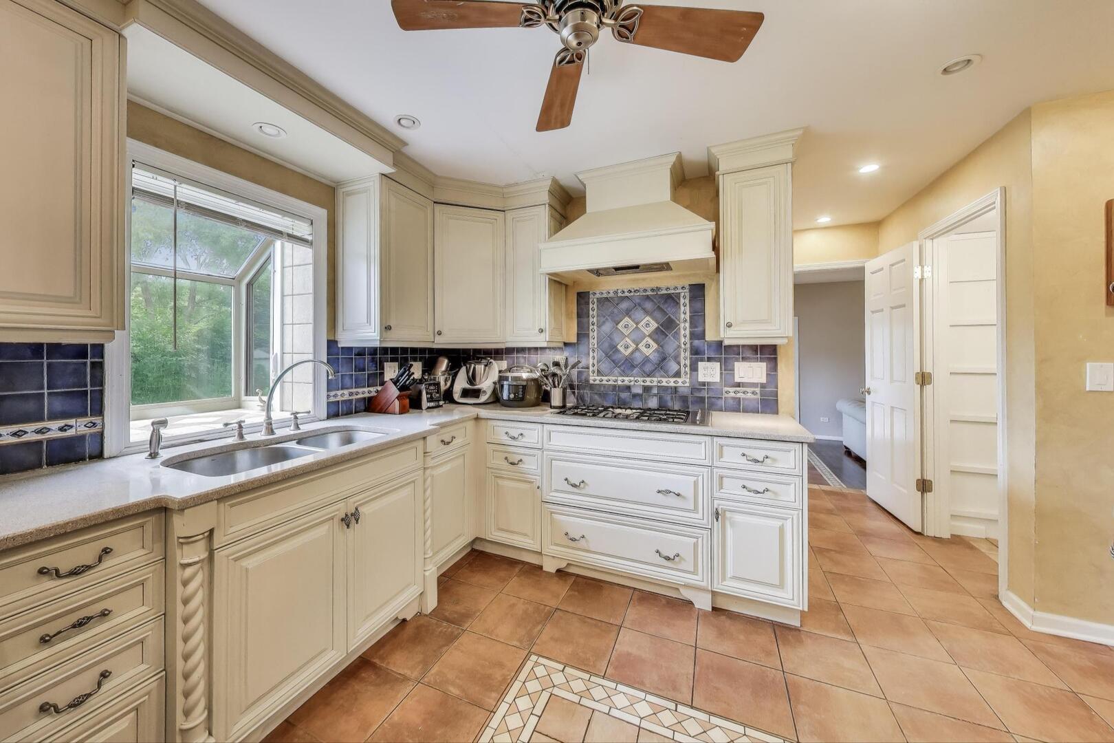 248 Beverly Road Barrington, IL 60010 - Photo 6 of 27 a kitchen with granite countertop a sink stainless steel appliances and cabinets