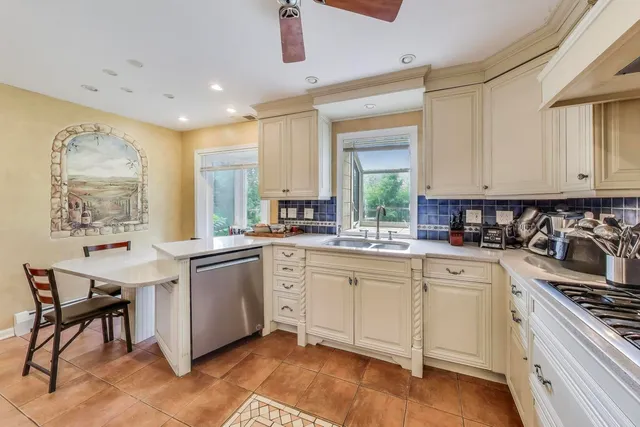 a kitchen with stainless steel appliances granite countertop a sink and cabinets