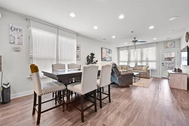 a view of a dining room with furniture window and wooden floor