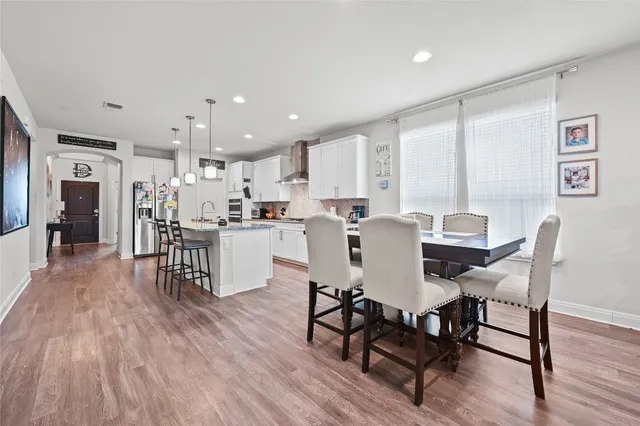 a view of a dining room with furniture and wooden floor