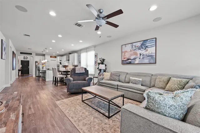 a living room with furniture and kitchen view