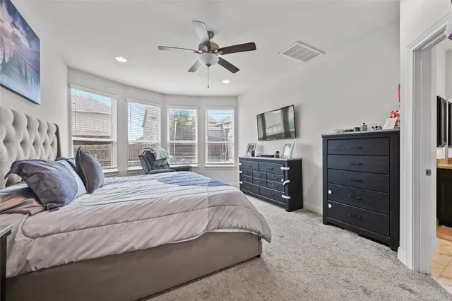 a bedroom with a bed and a dresser