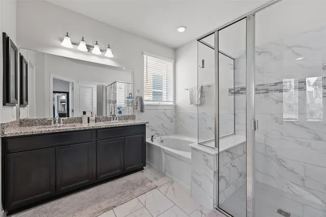 a spacious bathroom with a shower sink mirror and a bathtub