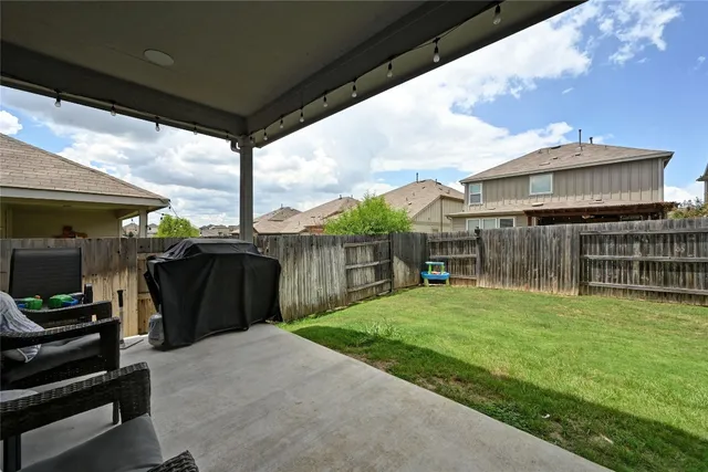 a view of a house with backyard porch and sitting area