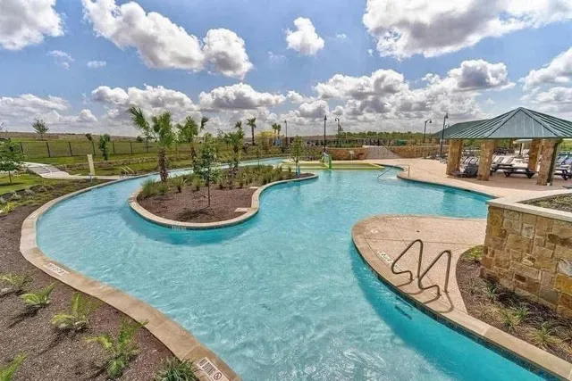 a view of a swimming pool and lounge chairs