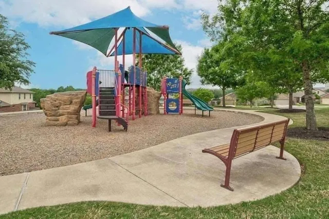 a backyard view of a house with trampoline fire pit tables and chairs