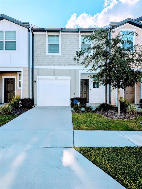 a front view of a house with a yard and garage