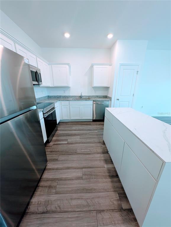 6215 Daerr Rdg Street Zephyrhills, FL 33542 - Photo 12 of 27 a large white kitchen with a sink a refrigerator and window