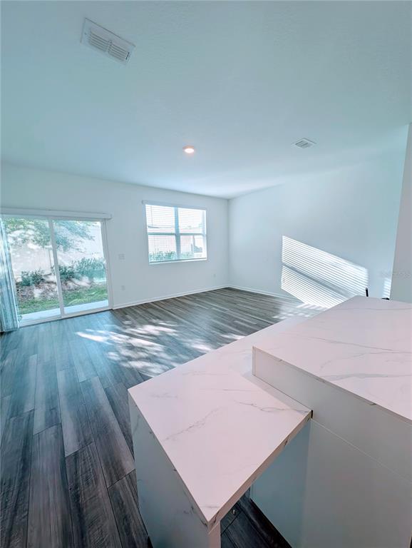 6215 Daerr Rdg Street Zephyrhills, FL 33542 - Photo 13 of 27 a view of an empty room with wooden floor and a window