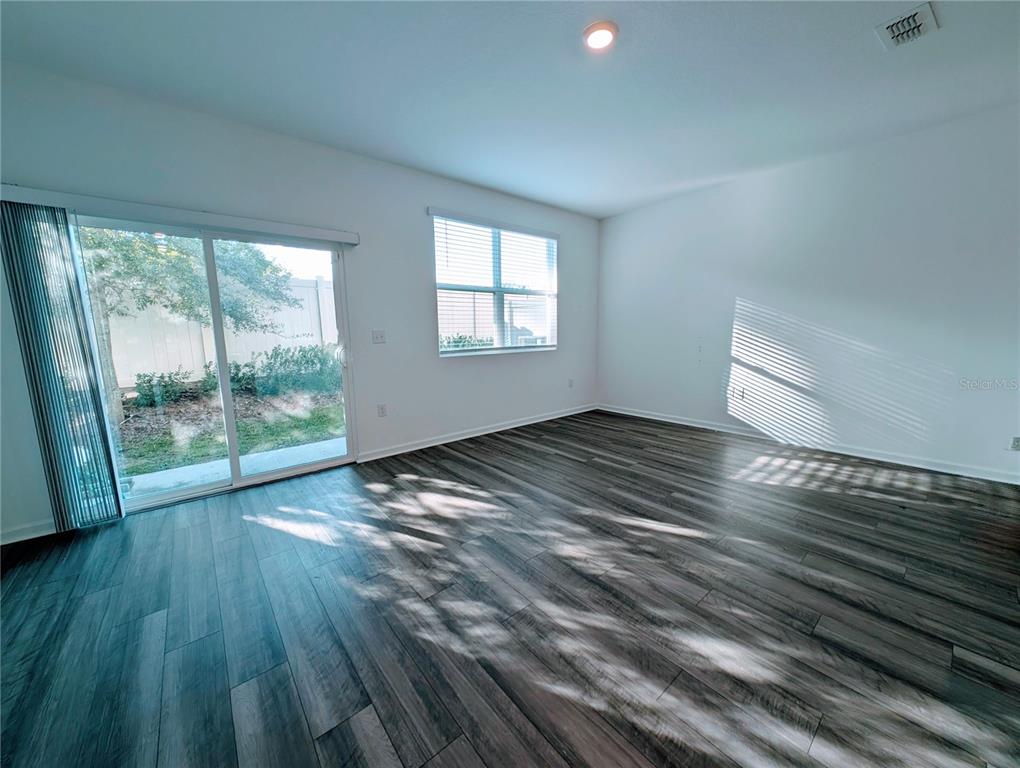 6215 Daerr Rdg Street Zephyrhills, FL 33542 - Photo 14 of 27 a view of empty room with wooden floor and fan