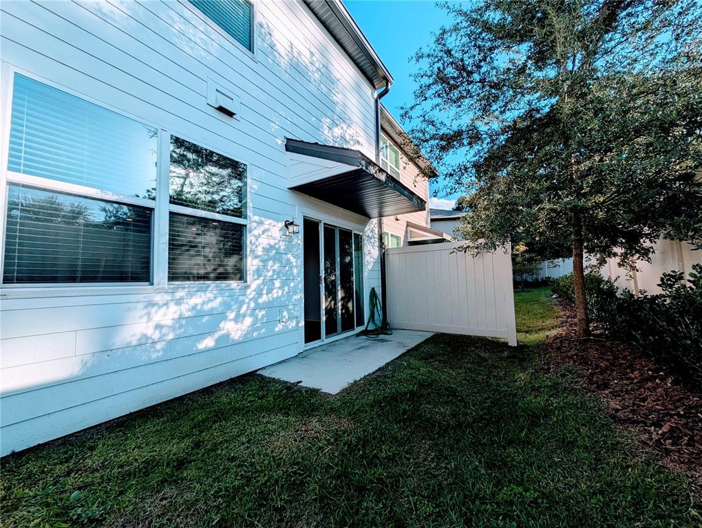 6215 Daerr Rdg Street Zephyrhills, FL 33542 - Photo 16 of 27 a view of a house with a small yard and a large tree