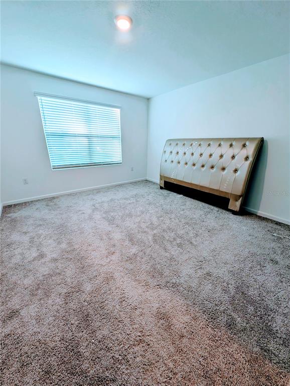 6215 Daerr Rdg Street Zephyrhills, FL 33542 - Photo 18 of 27 a view of an empty room with a window and dresser