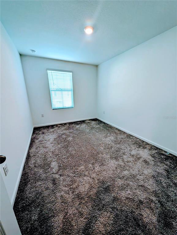 6215 Daerr Rdg Street Zephyrhills, FL 33542 - Photo 22 of 27 an empty room with a bench