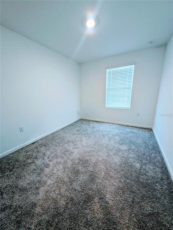 6215 Daerr Rdg Street Zephyrhills, FL 33542 - Photo 23 of 27 an empty room with a workbench