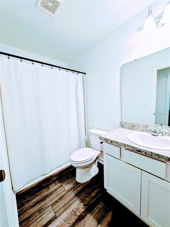 6215 Daerr Rdg Street Zephyrhills, FL 33542 - Photo 25 of 27 a bathroom with a granite countertop sink toilet and a mirror