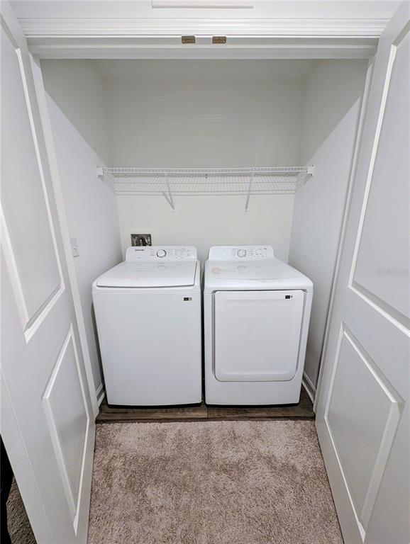 6215 Daerr Rdg Street Zephyrhills, FL 33542 - Photo 26 of 27 a utility room with dryer and washer