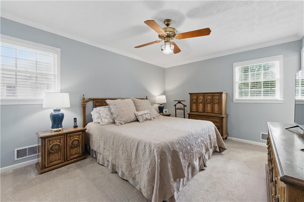 4205 Jeri Lynn Court Tucker, GA 30084 - Photo 25 of 34 a bedroom with a bed a window and a chandelier