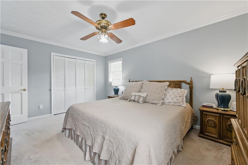 4205 Jeri Lynn Court Tucker, GA 30084 - Photo 26 of 34 a bedroom with a bed and a chandelier