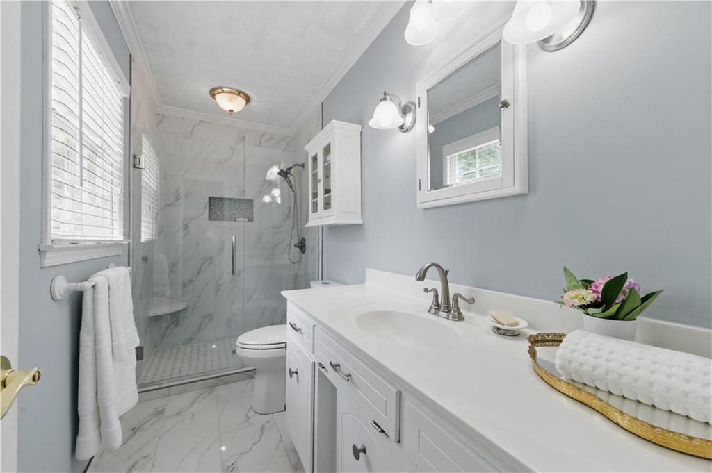 4205 Jeri Lynn Court Tucker, GA 30084 - Photo 27 of 34 a bathroom with a double vanity sink toilet and shower