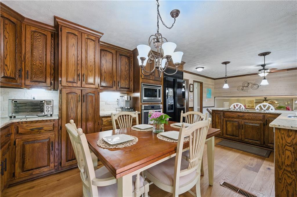 4205 Jeri Lynn Court Tucker, GA 30084 - Photo 6 of 34 a view of a dining room with furniture a kitchen and chandelier