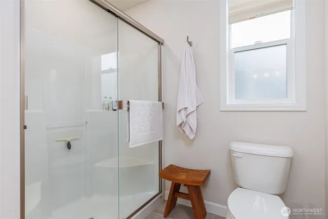 a white toilet sitting next to a bathroom sink