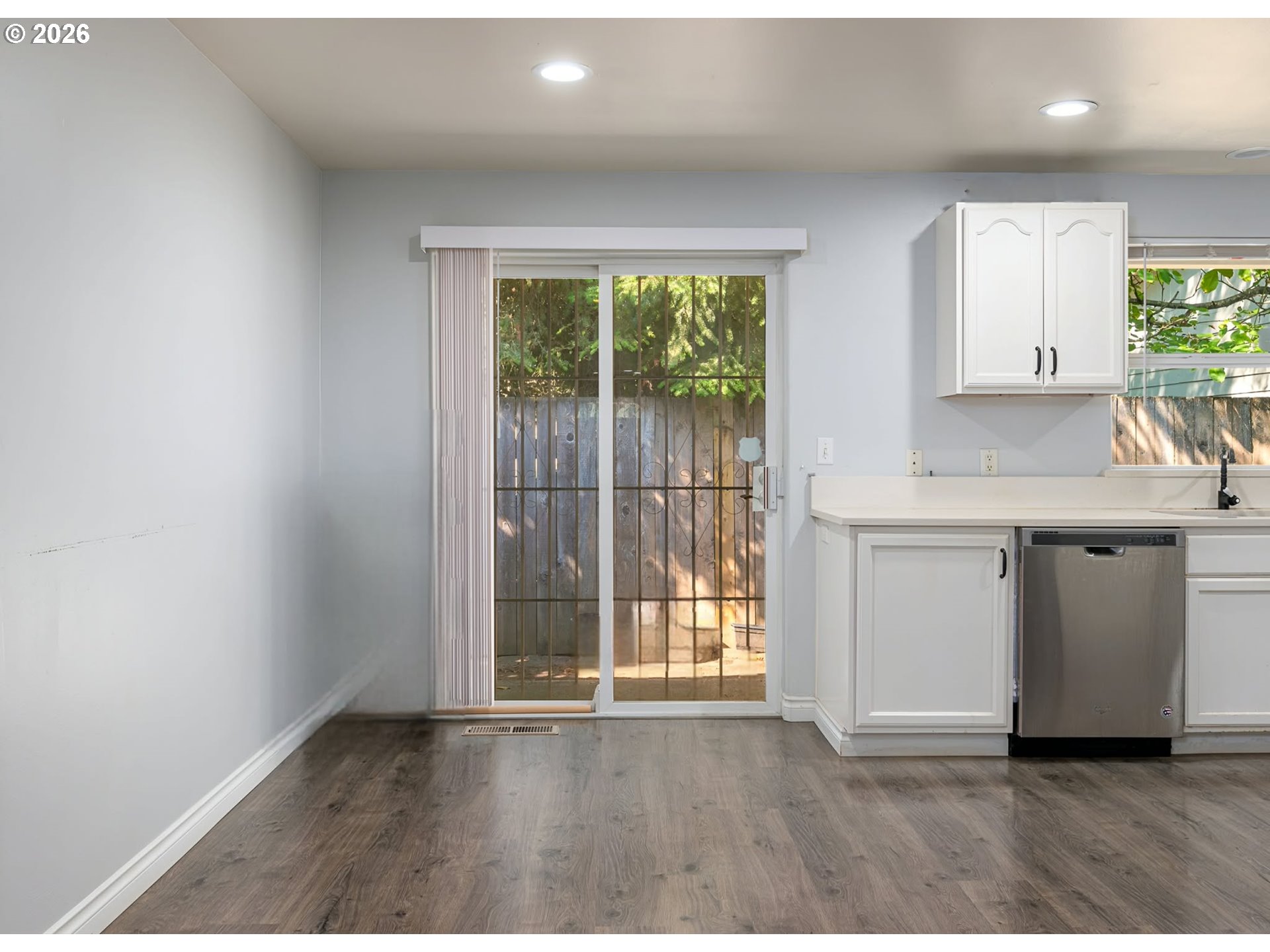 15310 Southeast Stark Street Portland, OR 97233 - Photo 14 of 18 a kitchen with a wooden floor and a large window