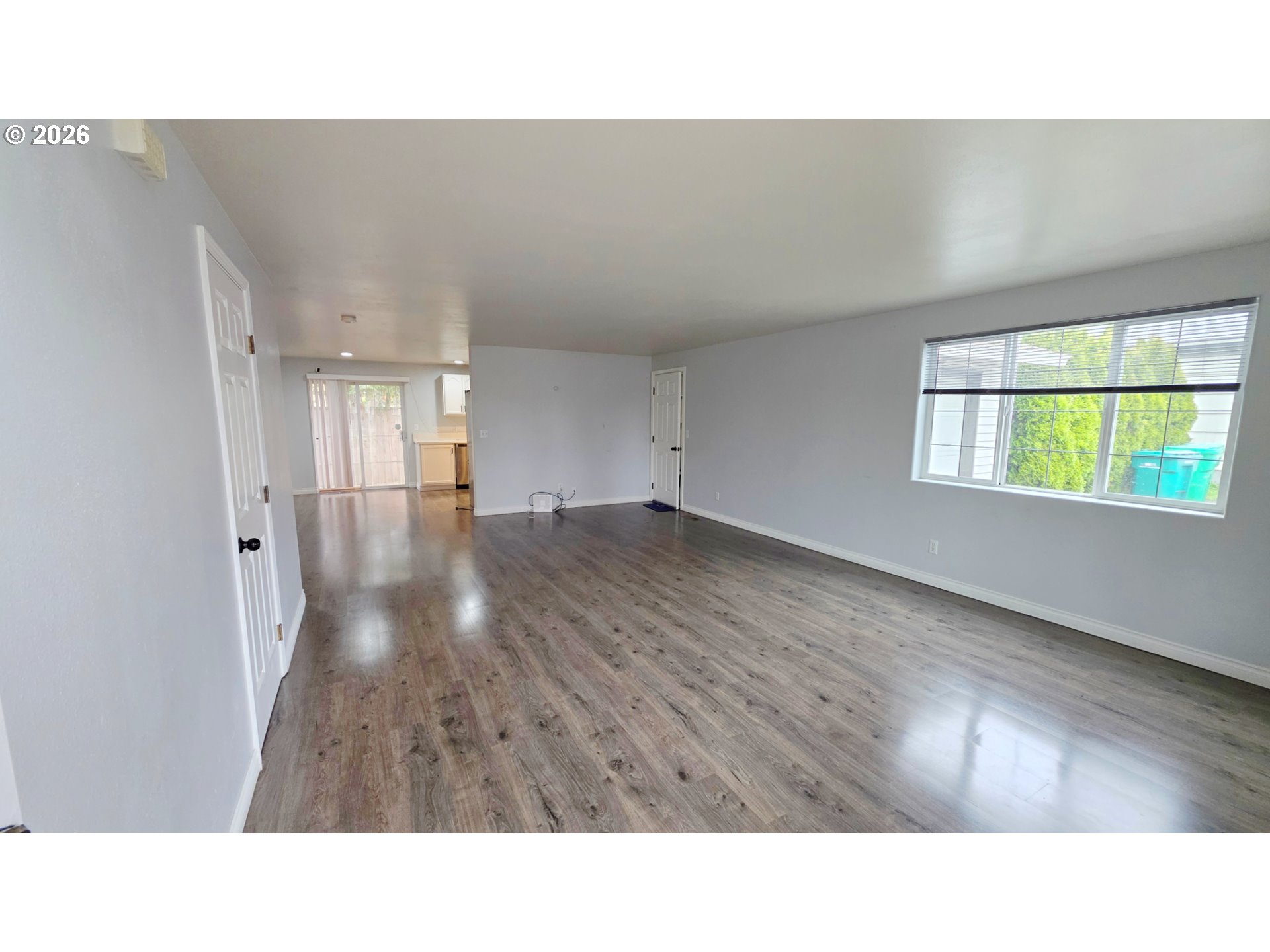 15310 Southeast Stark Street Portland, OR 97233 - Photo 4 of 18 a open hall with a hardwood floor