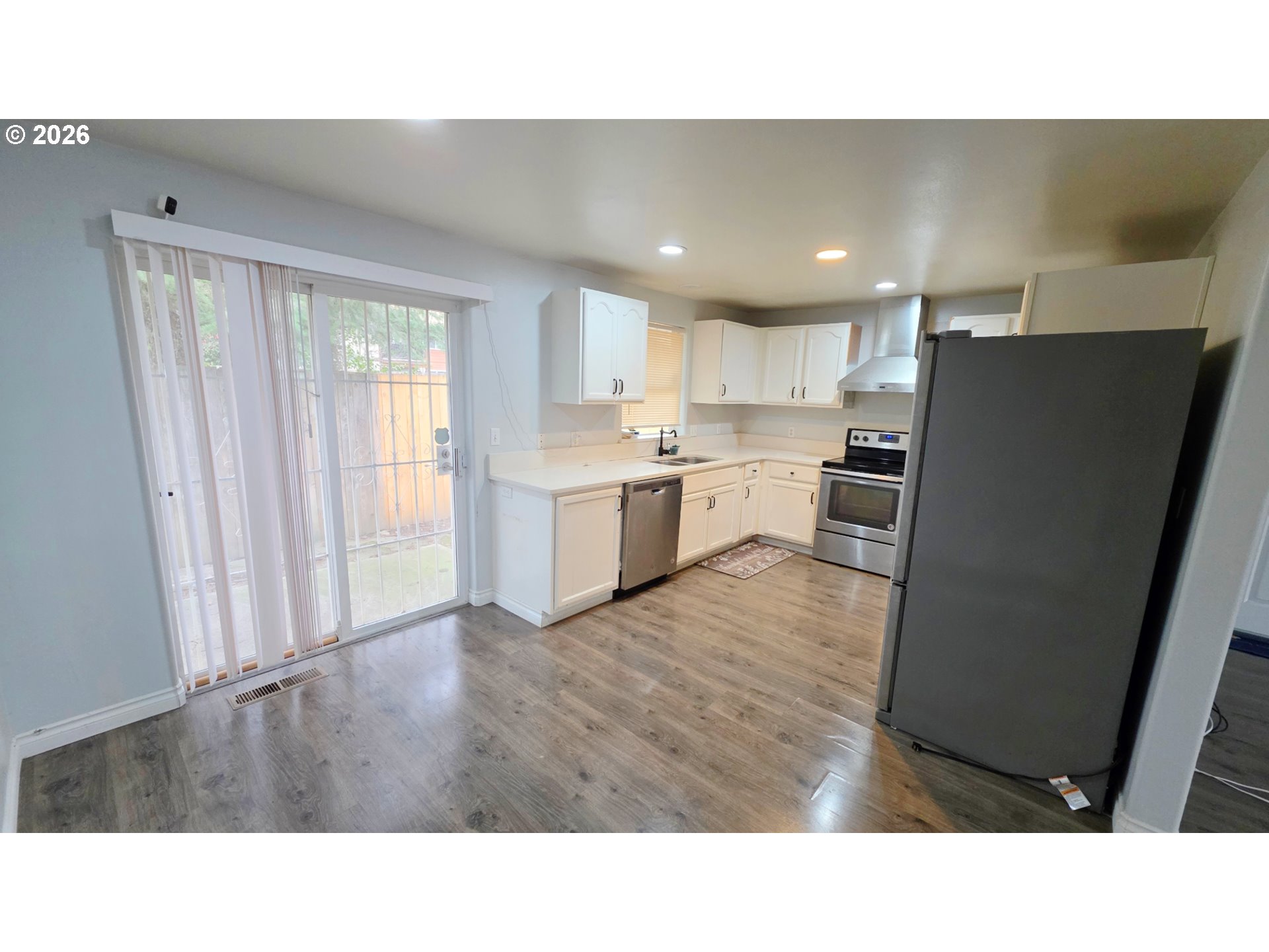 15310 Southeast Stark Street Portland, OR 97233 - Photo 7 of 18 a open kitchen with refrigerator sink and cabinets