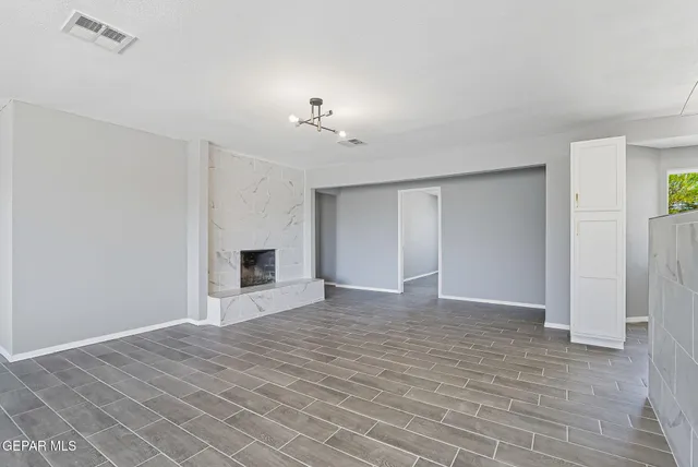 a view of empty room with a fireplace
