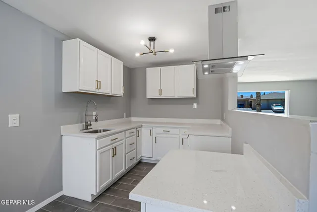 a kitchen with stainless steel appliances granite countertop a sink and cabinets