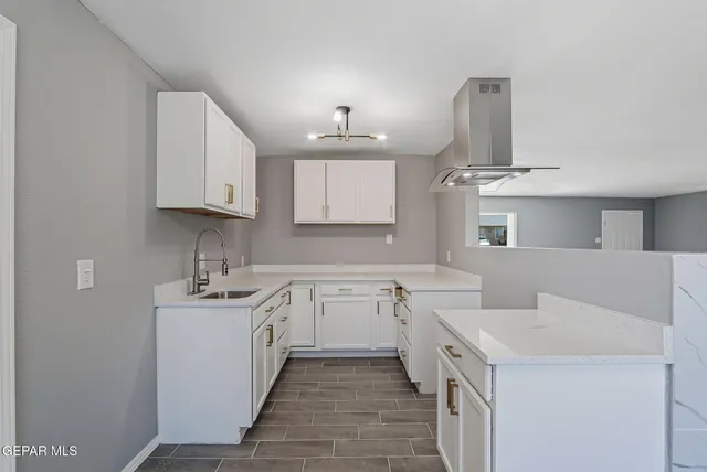 a kitchen with a sink stove and cabinets