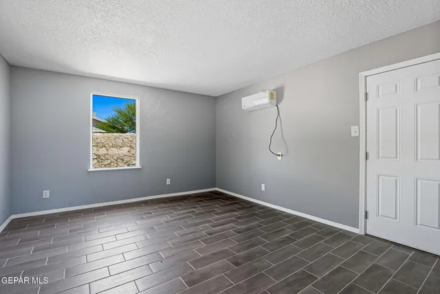 a view of room with window and wooden floor