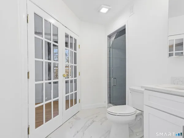 a bathroom with a toilet and a shower
