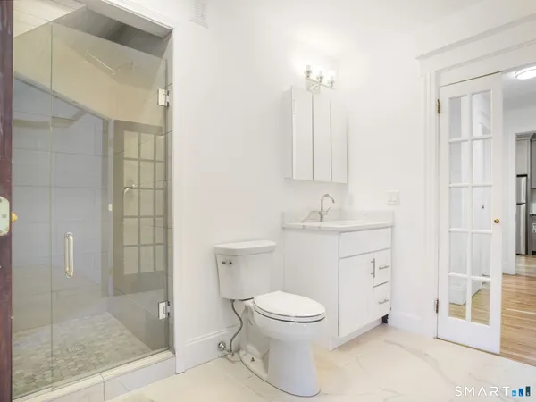 a bathroom with a toilet a sink and shower