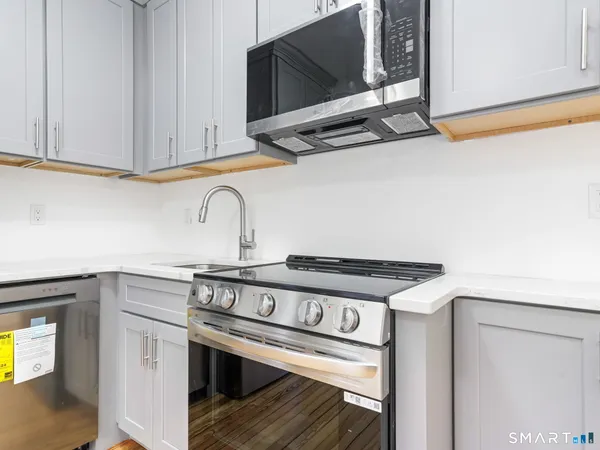 a kitchen with granite countertop a stove and a sink