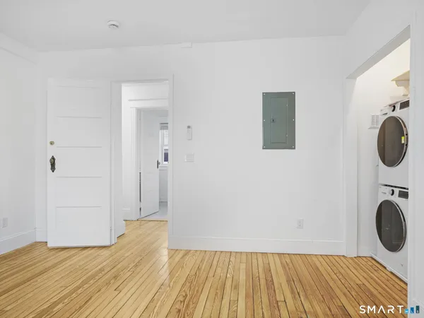 a view of a room with wooden floor and white doors