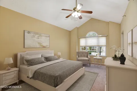 a bedroom with a large bed and a chandelier